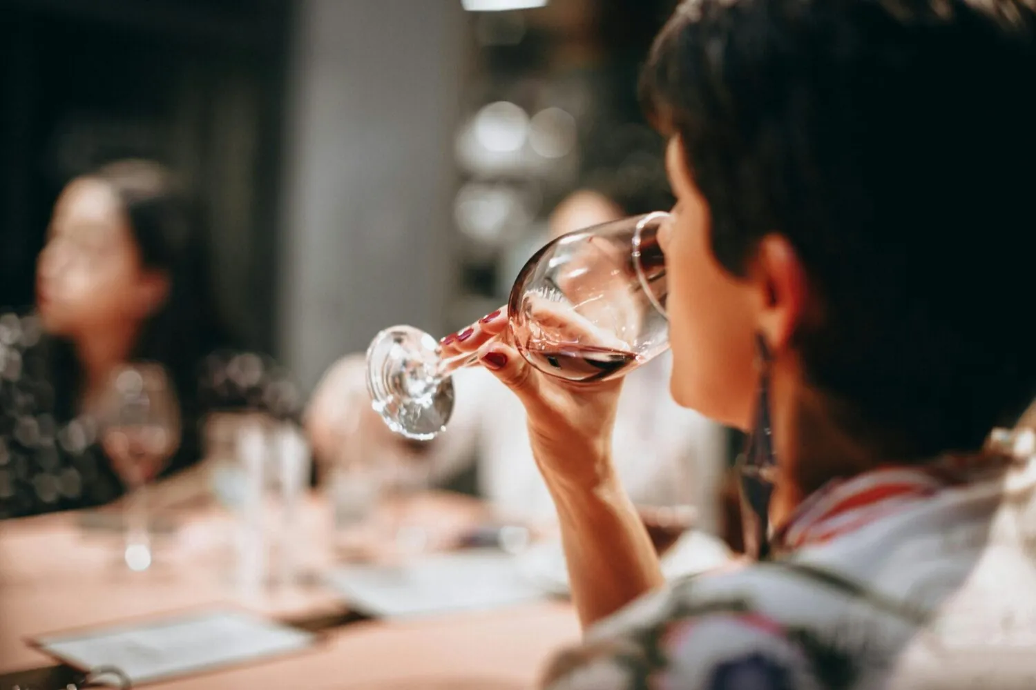 Women relaxing with glasses of wine in a social setting