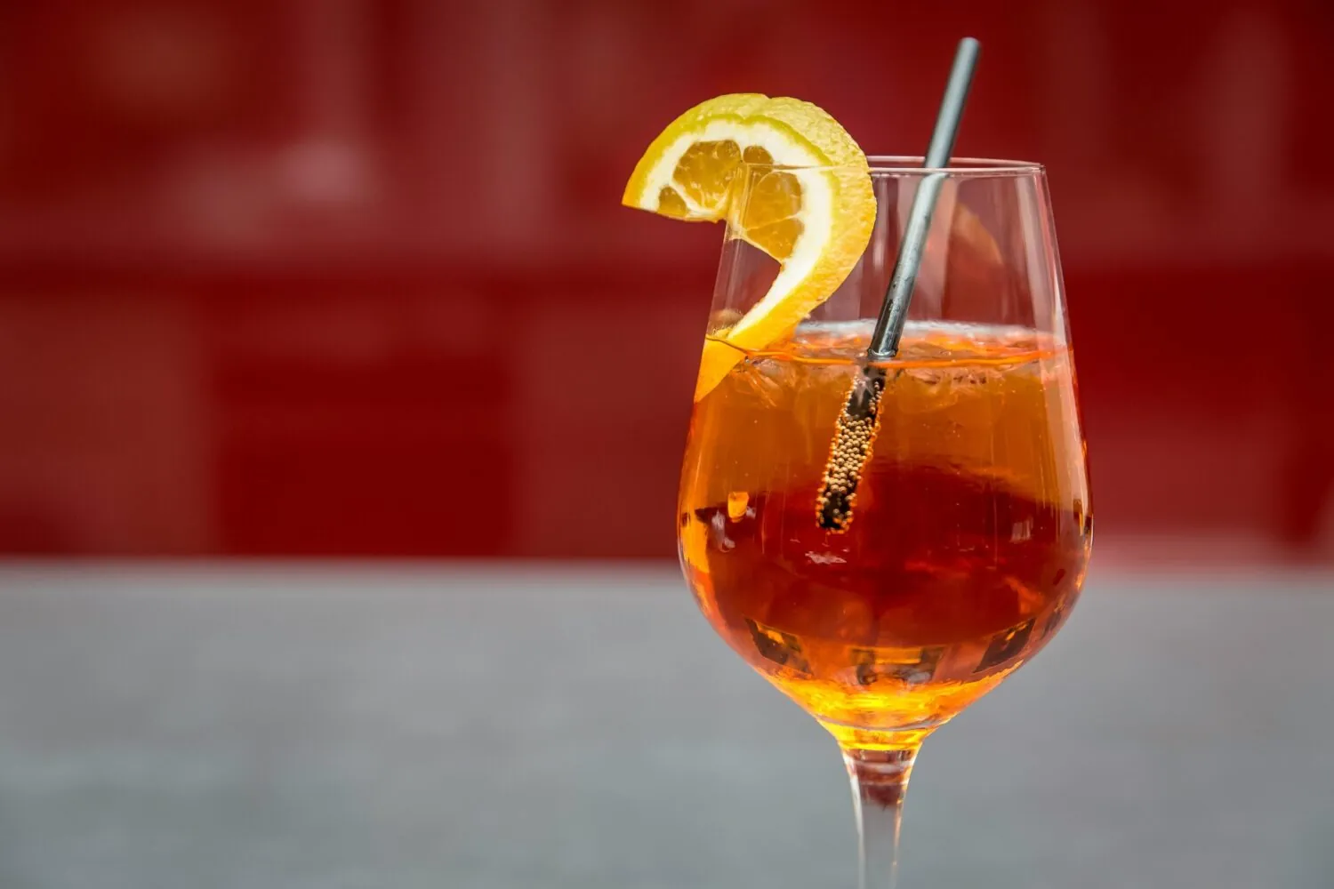 Colorful fruity cocktail served with a straw and fresh garnish