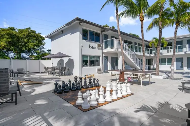 The Garden Hotel & Resort featuring a human-sized giant chess set on an outdoor patio.