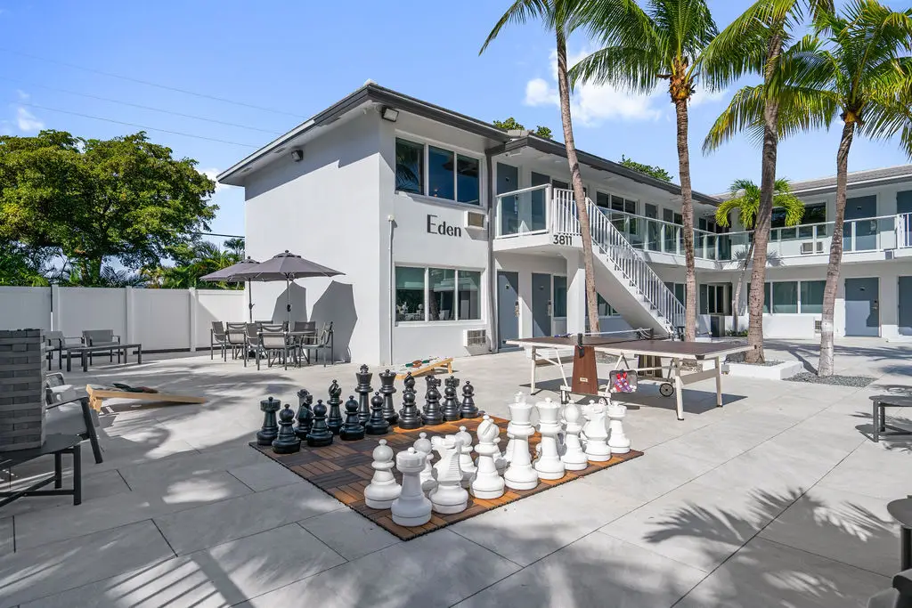 The Garden Hotel & Resort featuring a human-sized giant chess set on an outdoor patio.