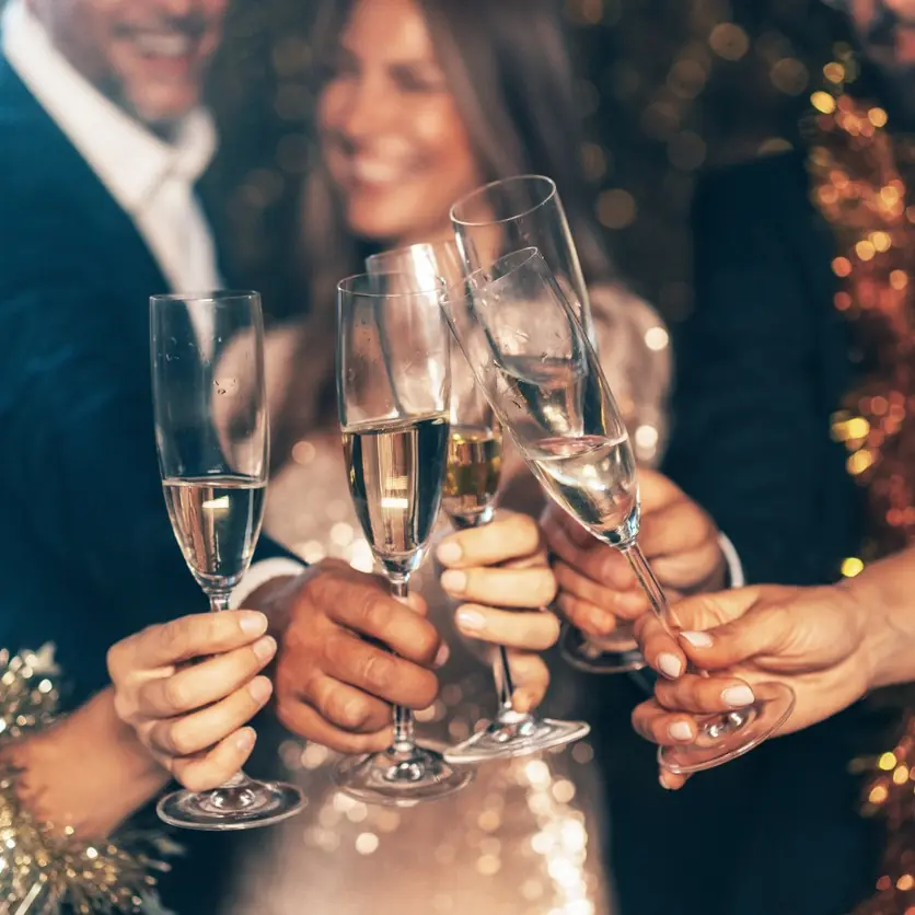 Group of people clinking champagne glasses in celebration