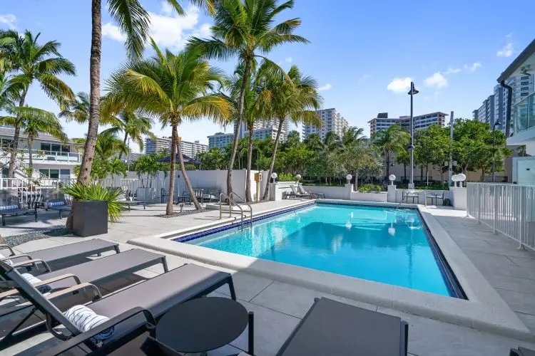 Luxury Hotel Terrace With Pool, Palm Trees And Comfortable Sun Loungers
